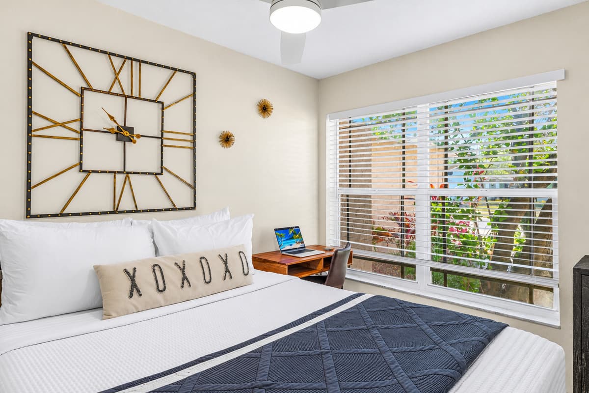 Relaxing queen bedroom featuring cozy décor and peaceful backyard views.