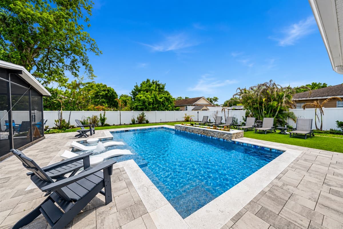 Stunning private pool area with lounge seating, spacious deck, and relaxing resort-style atmosphere.
