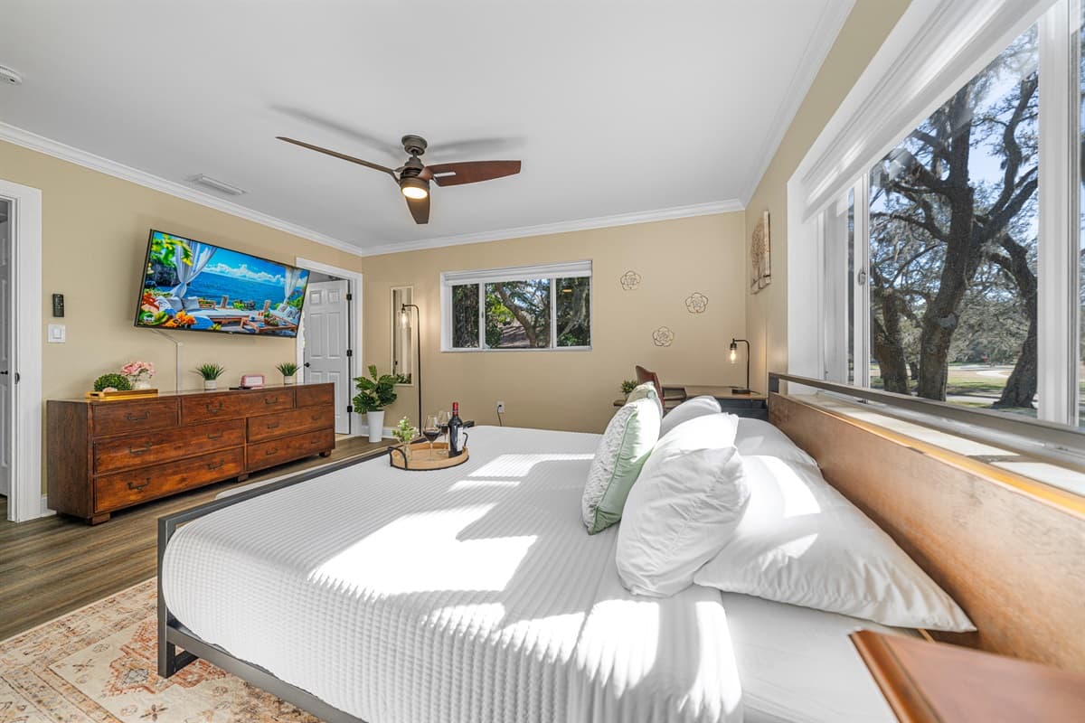 Designed for relaxation, this bedroom features a king bed, warm tones, and a bright, airy layout.
