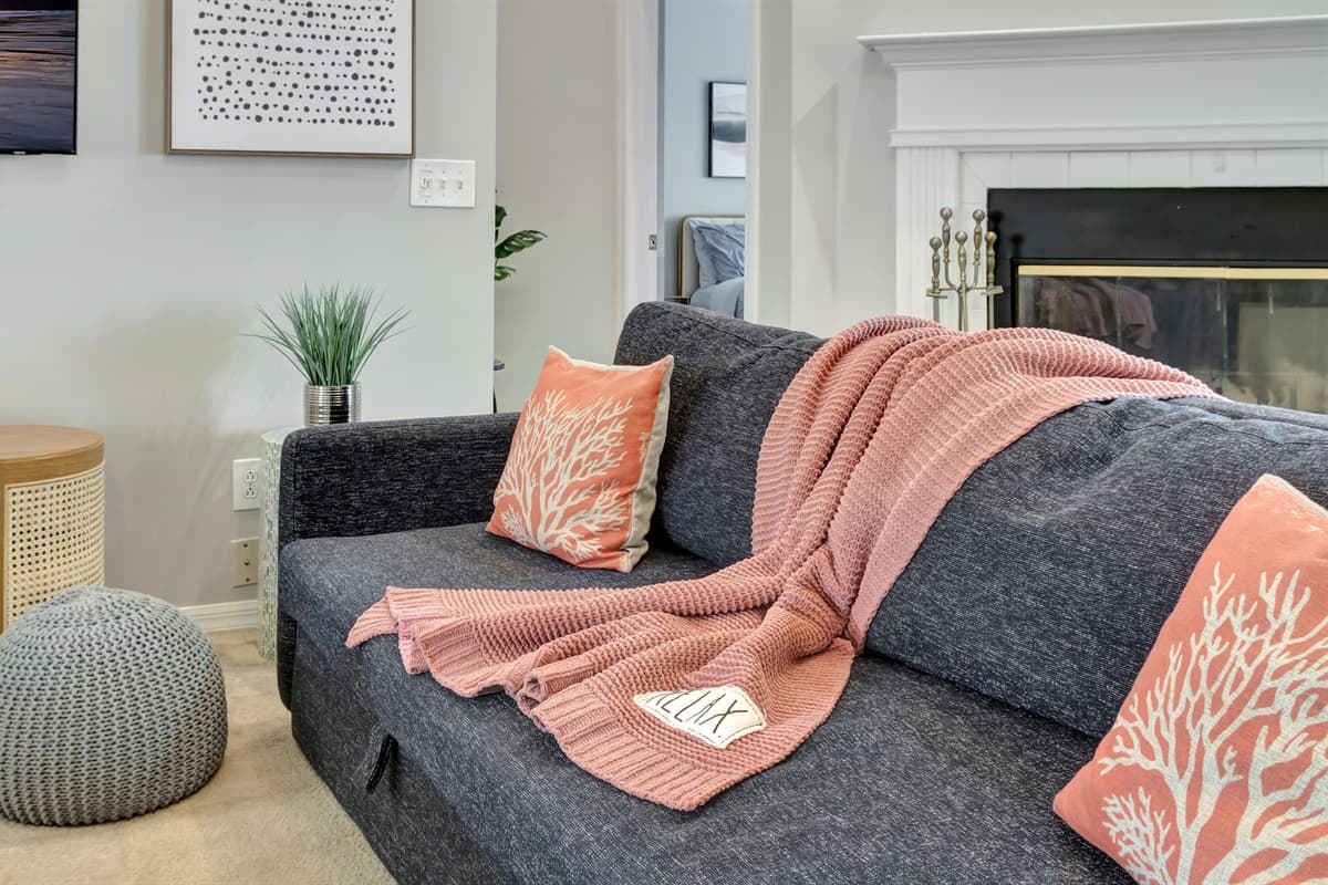 These delightful accents of the pastel-colored throw pillows  not only provide extra comfort but also infuse the space with a playful and inviting vibe.
