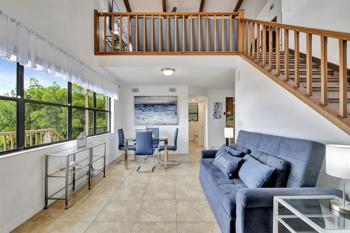 Adjacent to the couch, a charming seating area by the window awaits, offering a prime vantage point to soak in the breathtaking views of the surrounding landscape.