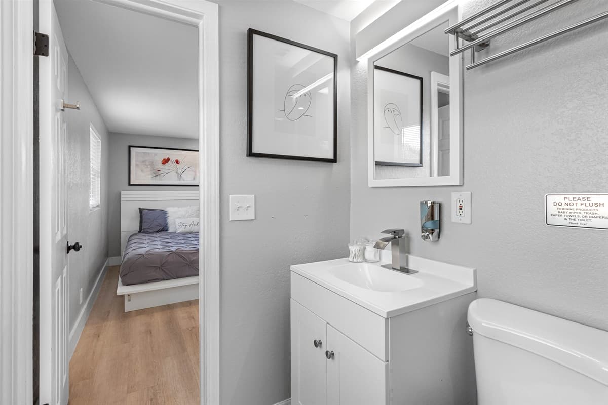 This elegant space combines a convenient toilet, stylish vanity, and a refreshing walk-in shower.