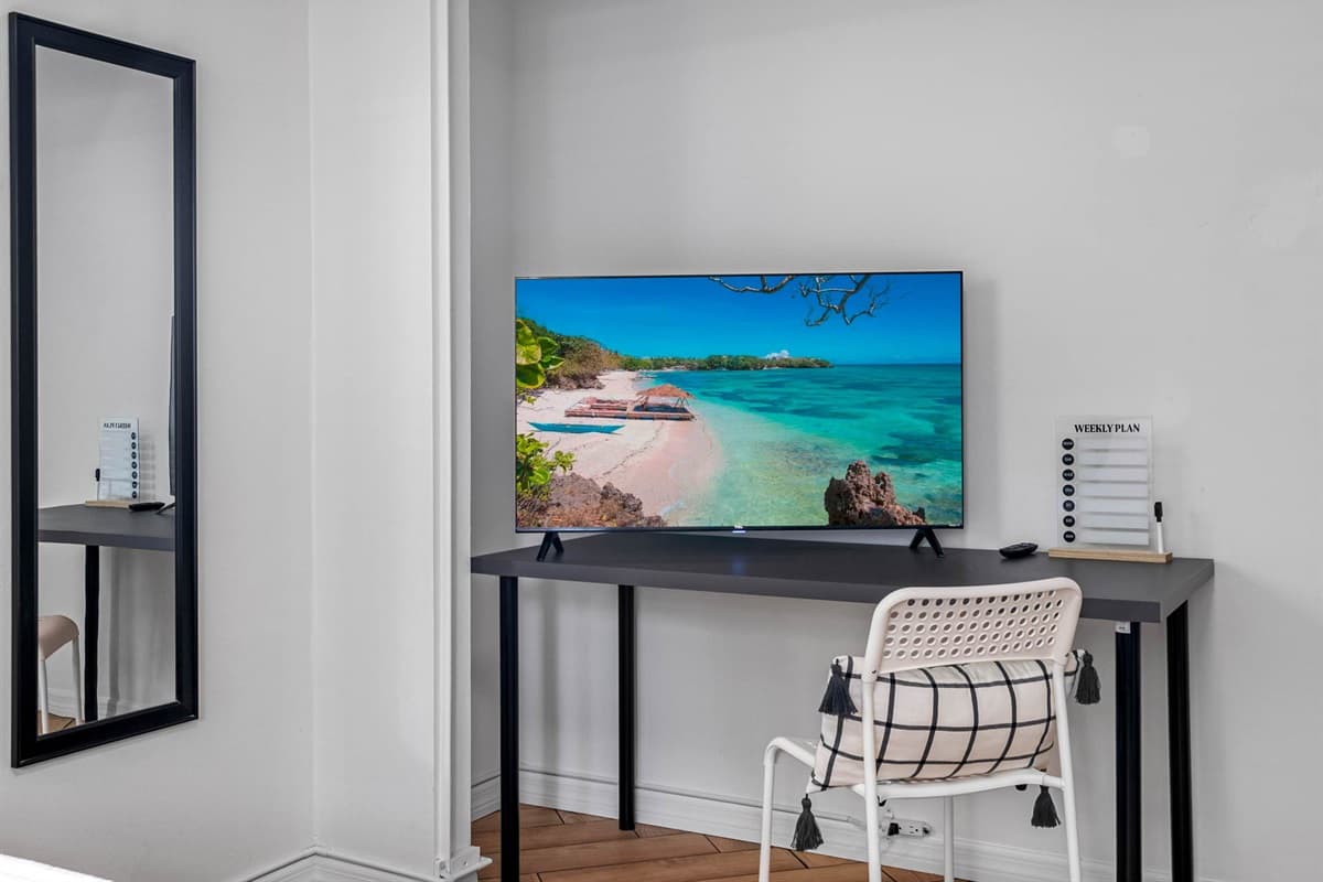 Stream your favorite shows, sip wine in bed, or simply unwind beneath the soft glow of the designer ceiling fixture.