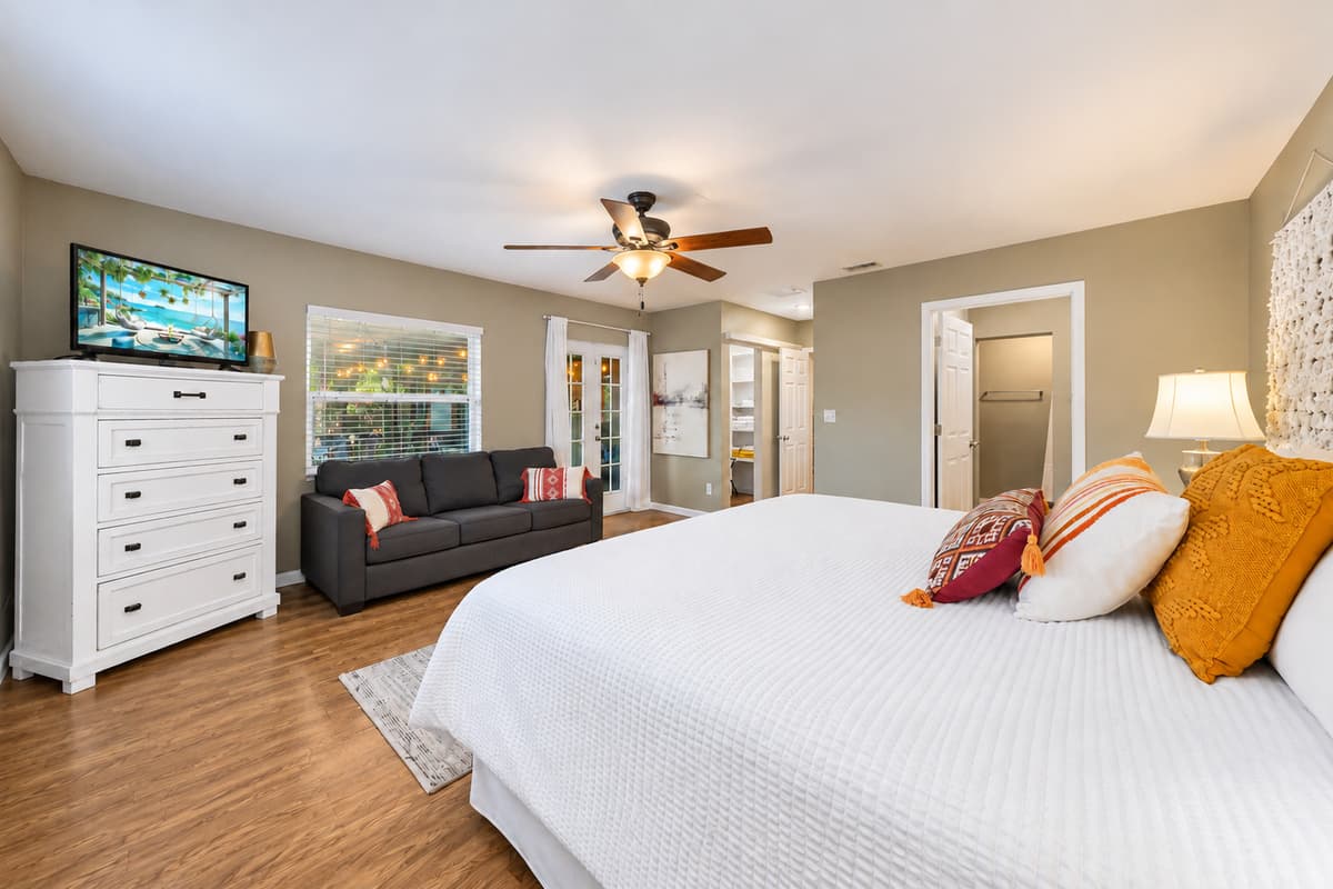 Large primary suite with stylish furnishings, TV, and a relaxing open layout.