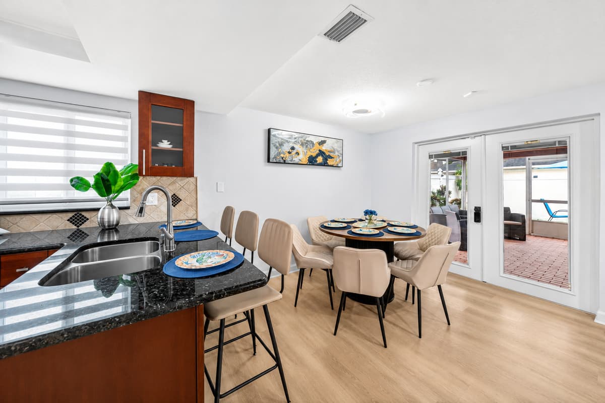 Kitchen breakfast bar and dining area offering convenient seating for casual meals, morning coffee, and family conversations.