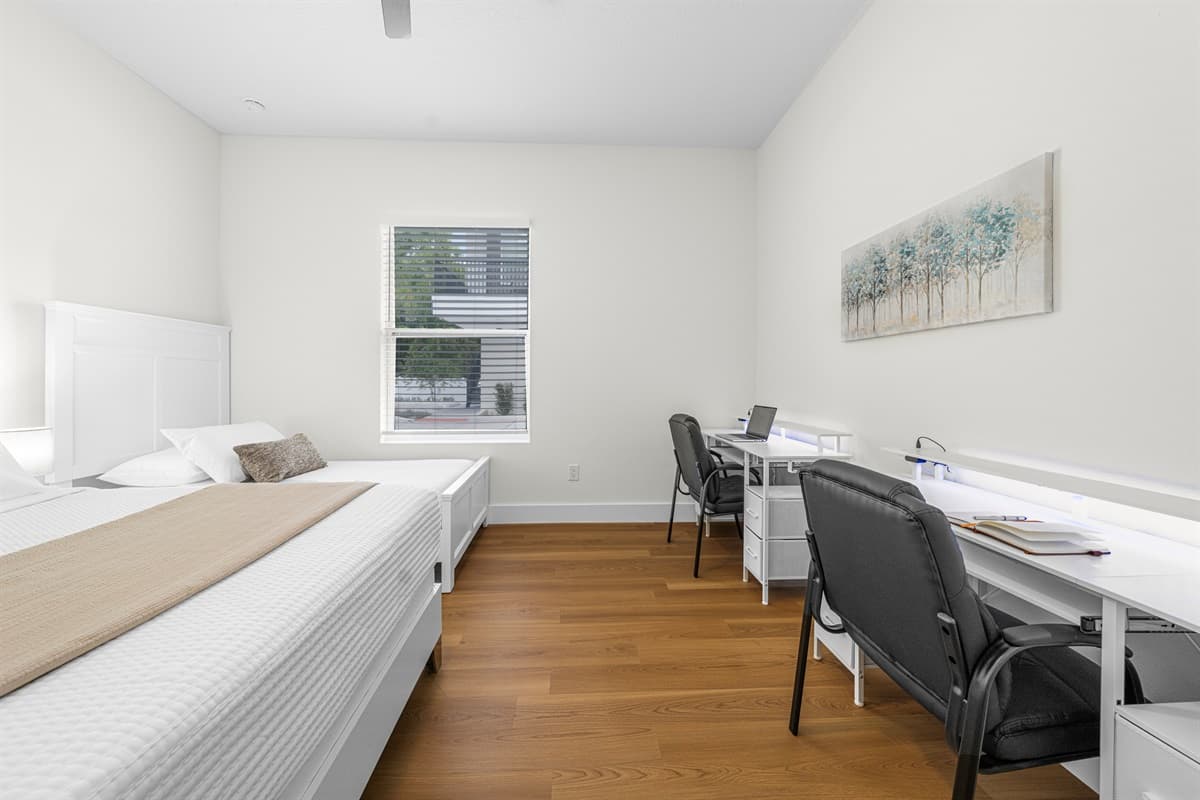 Bright bedroom with desk area and plenty of space to relax or work.
