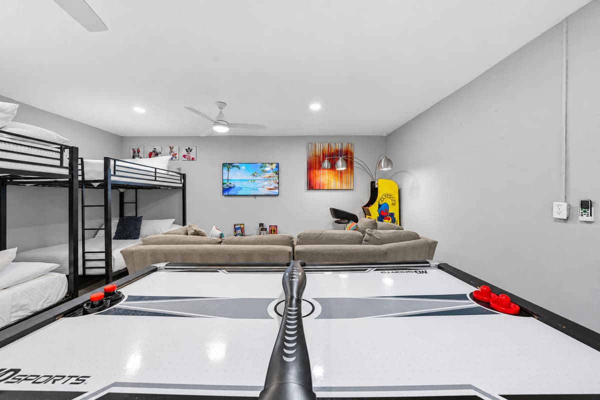 Spacious recreation room with bunk beds, games, and entertainment for guests of all ages.