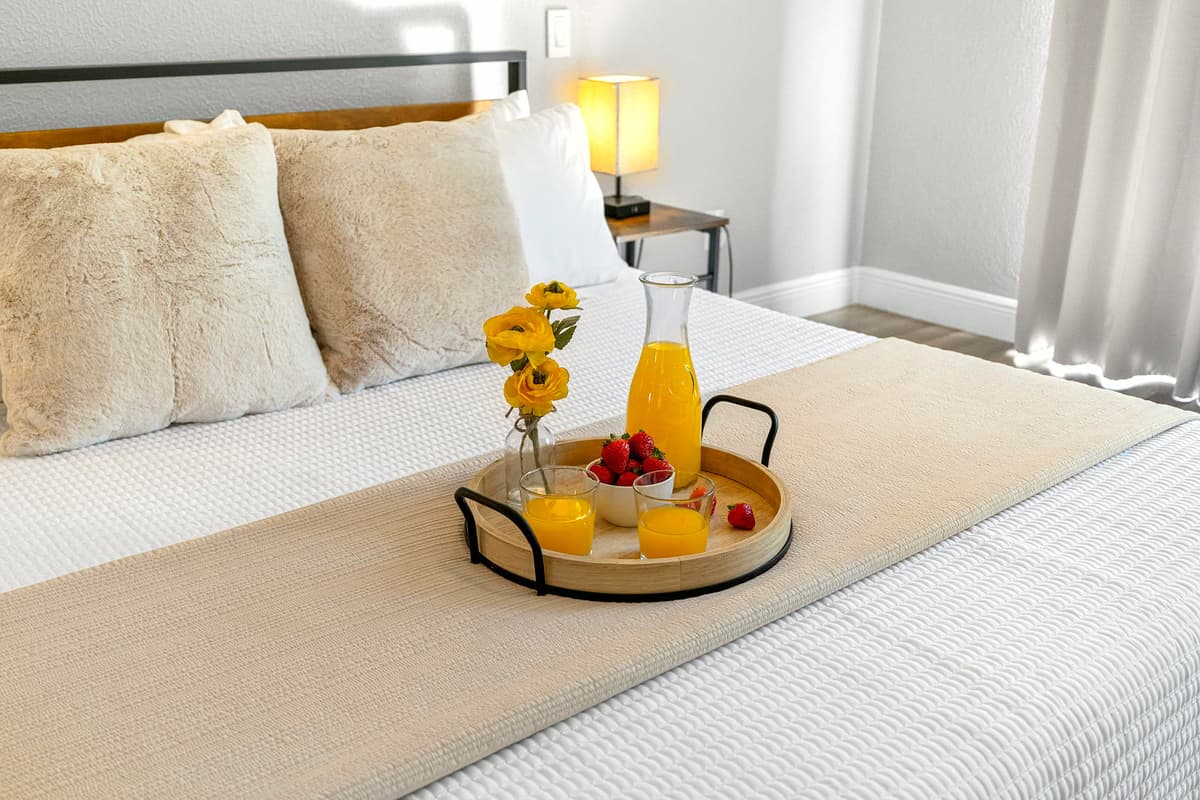 Unwind in the serene master bedroom with sleek décor, warm lighting, and private ensuite.