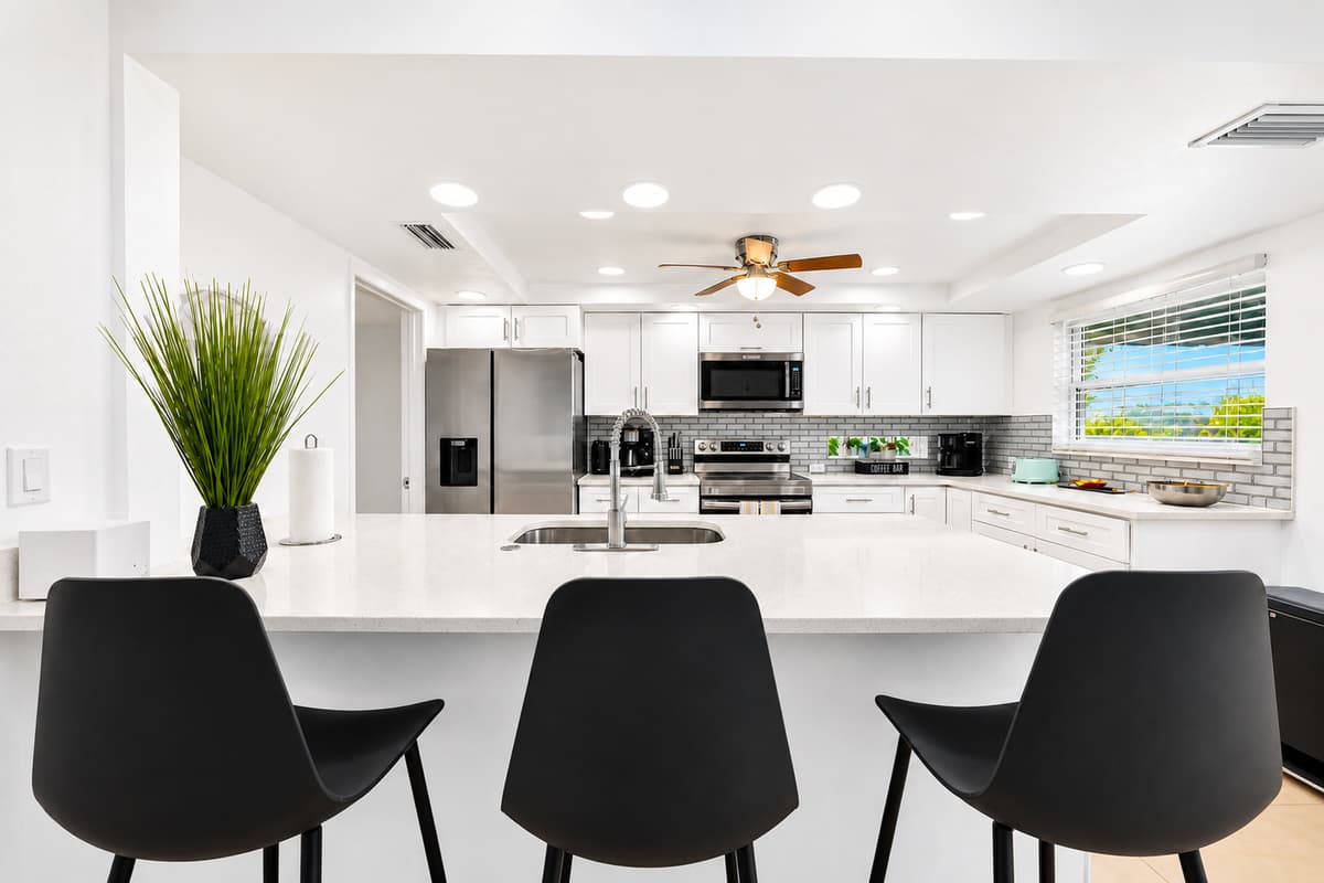 Large kitchen island with bar seating, perfect for gathering, dining, and entertaining.