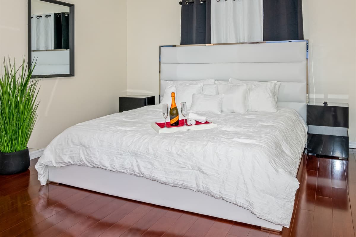 The bed is the centerpiece of the room, with its plush mattress, inviting you to sink into a deep slumber.