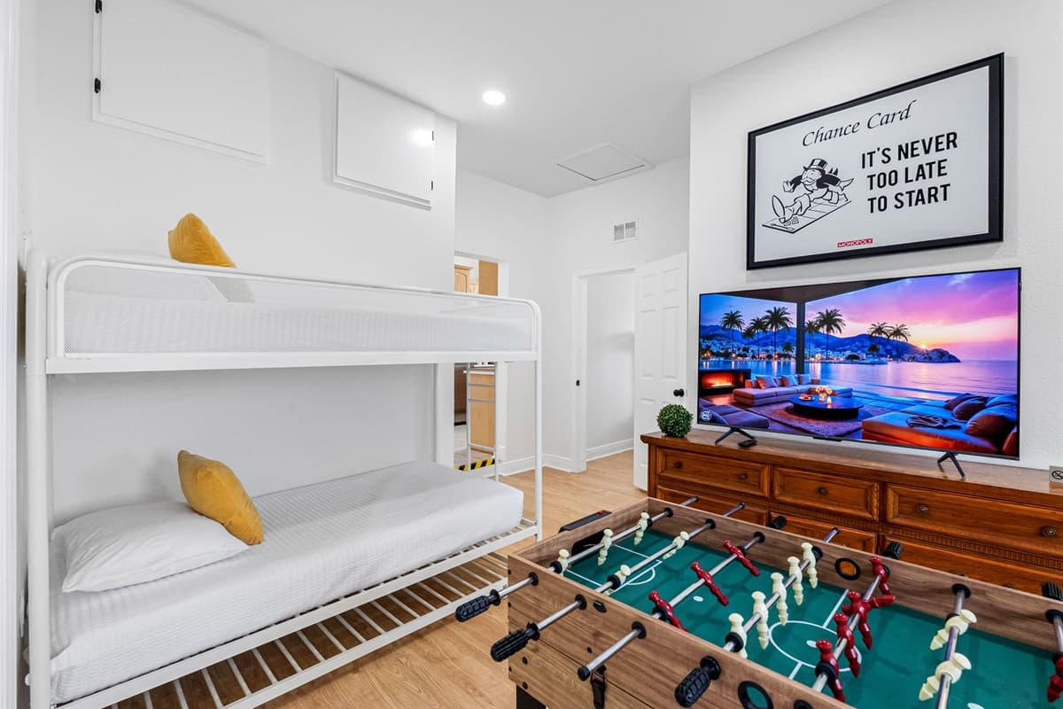 This fun and versatile entertainment room is perfect for guests of all ages. It features a comfortable bunk bed setup, making it ideal for kids or extra guests, along with a large flat-screen TV for movie nights and relaxation.