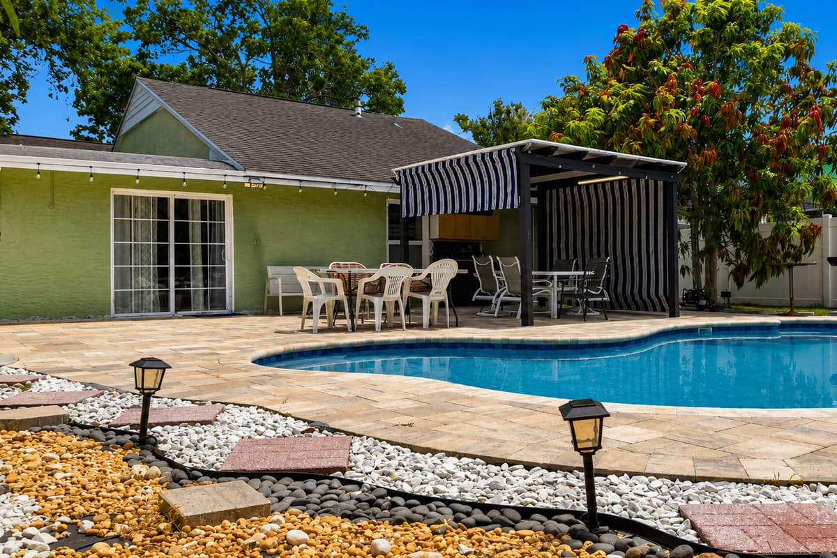 Enjoy your own tropical backyard oasis featuring a sparkling private pool and plenty of outdoor space.