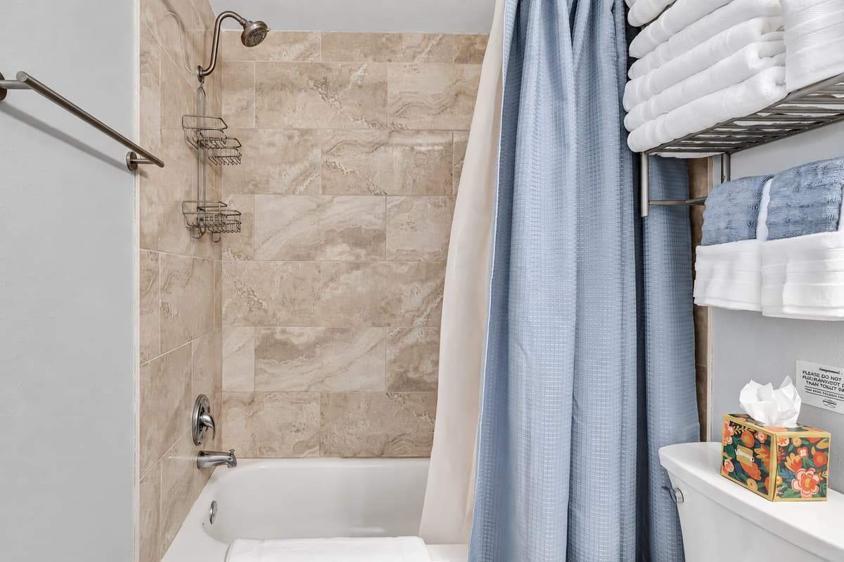 Complete with a sleek walk-in shower, modern toilet, and a chic vanity.