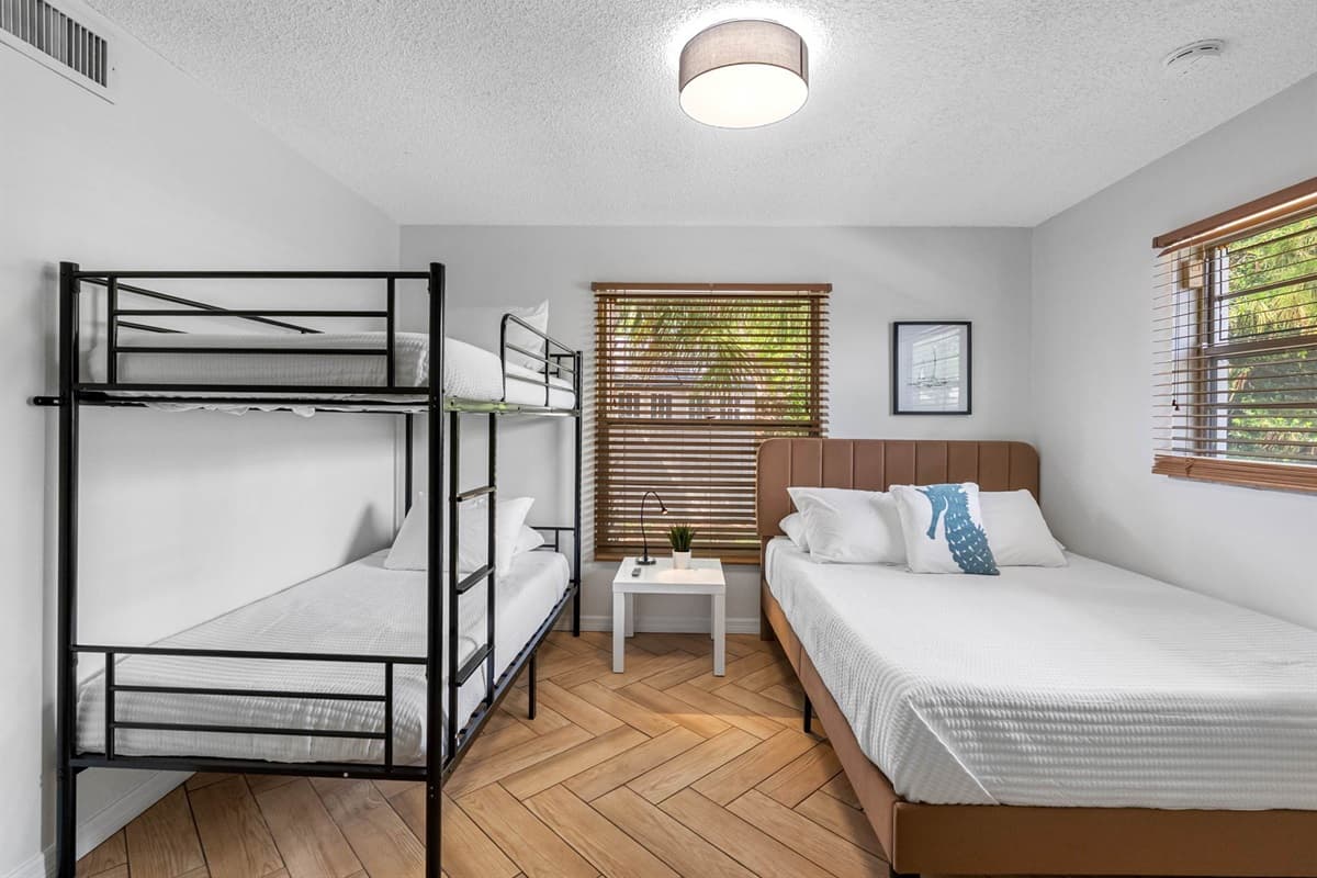 Designed with families in mind, this cozy bedroom features a comfy queen-size bed and a bunk bed—perfect for kids or friends traveling together.
