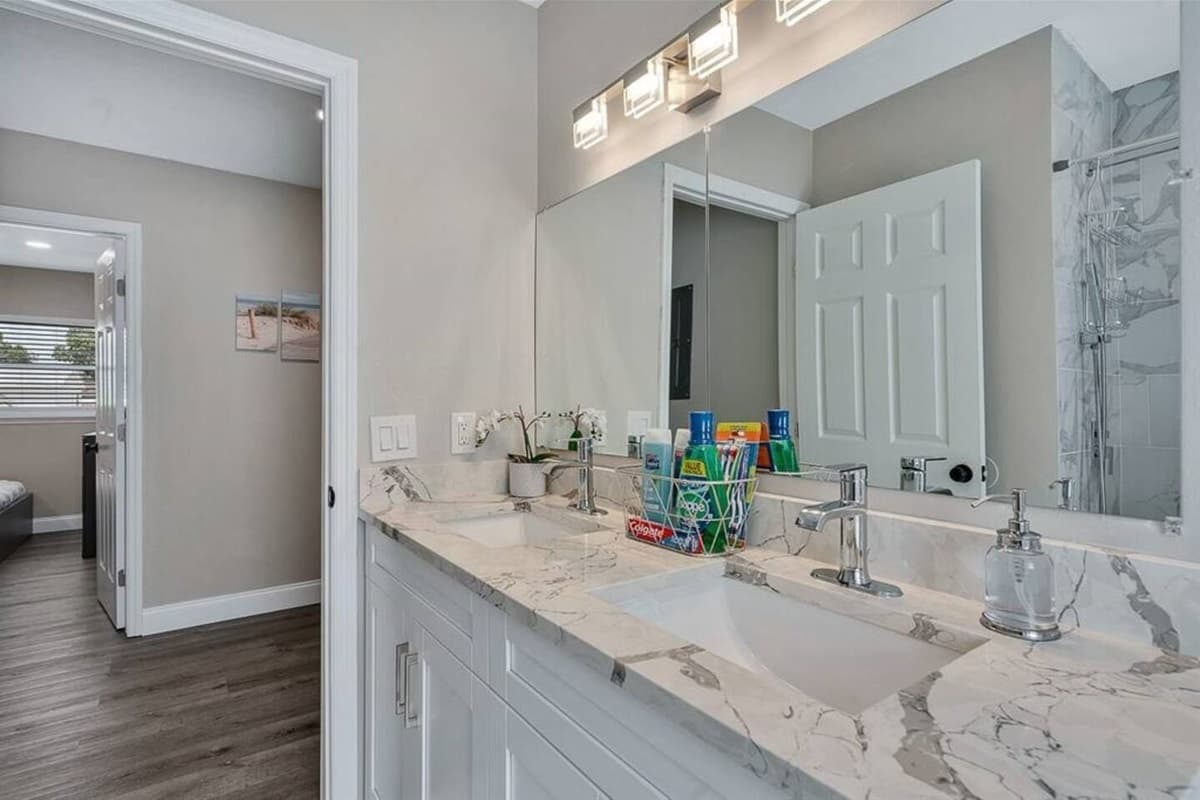 Stunning bathroom with sink, toilet, and walk-in shower.  Enjoy a relaxing bath after a long day of travel from your home to your home away from home. If you like this property, send us a message now!