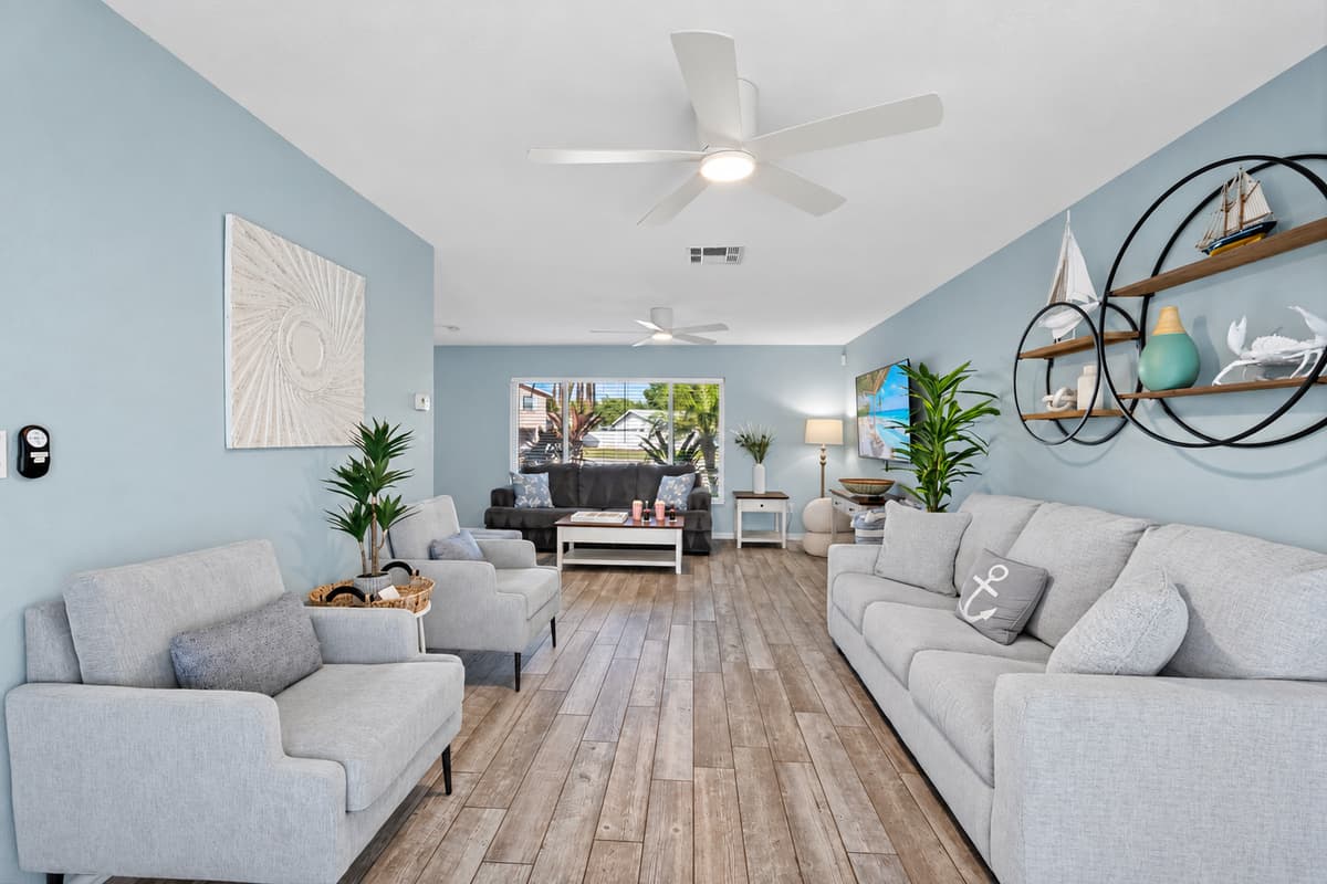 From cozy seating to poolside views, this living room is designed for comfort and connection.