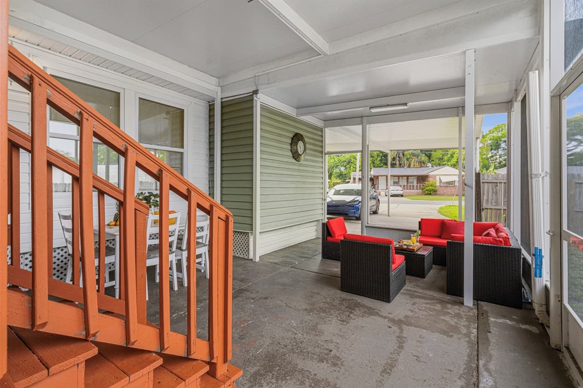 Covered patio with multiple seating areas—perfect for entertaining or unwinding.