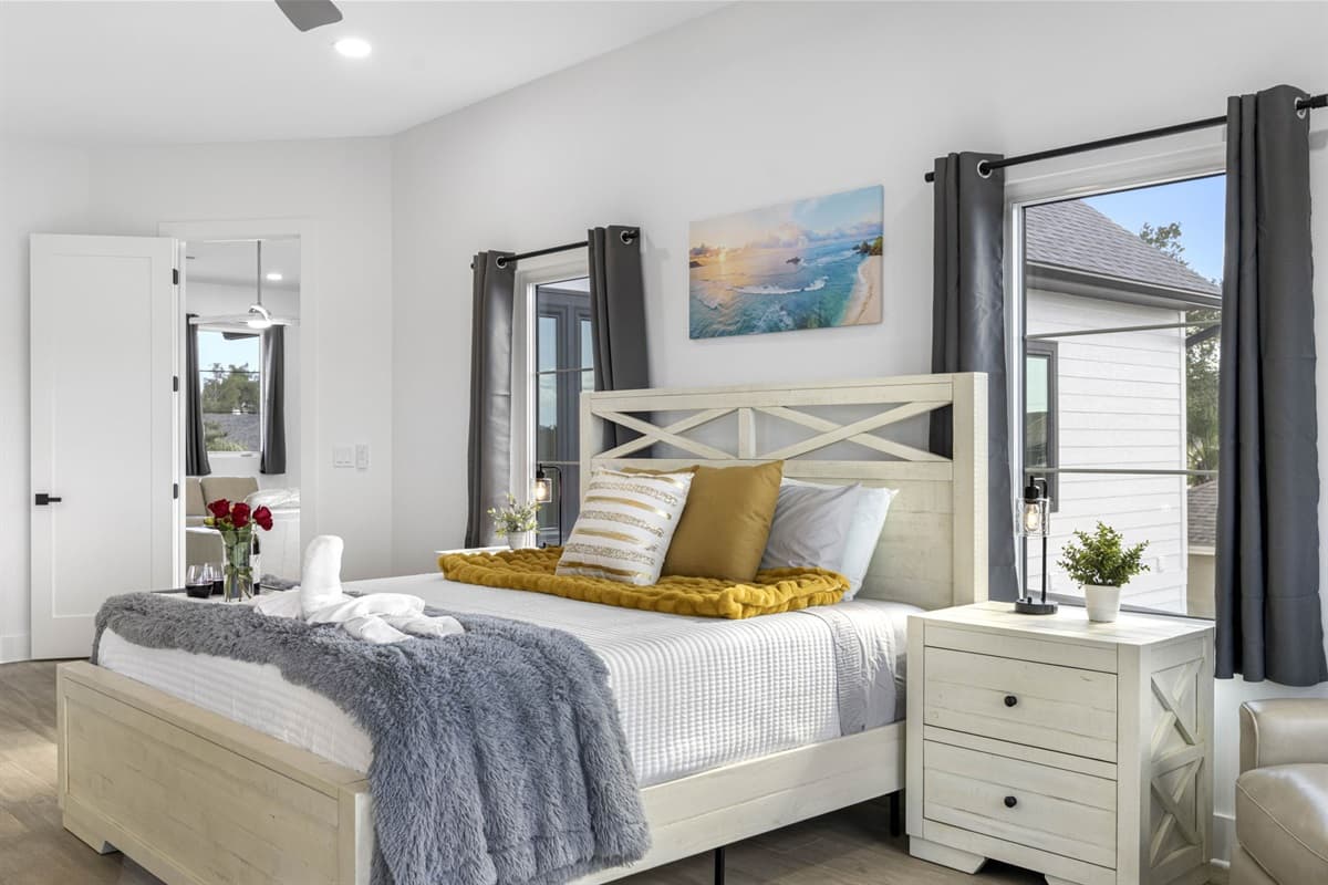 This master suite exudes luxury, featuring a plush king-size bed with soft linens and an elegant design.