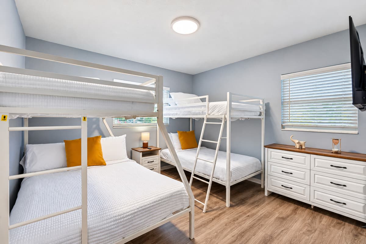 Spacious bunk bedroom featuring two sturdy bunk beds and cozy sleeping spaces.