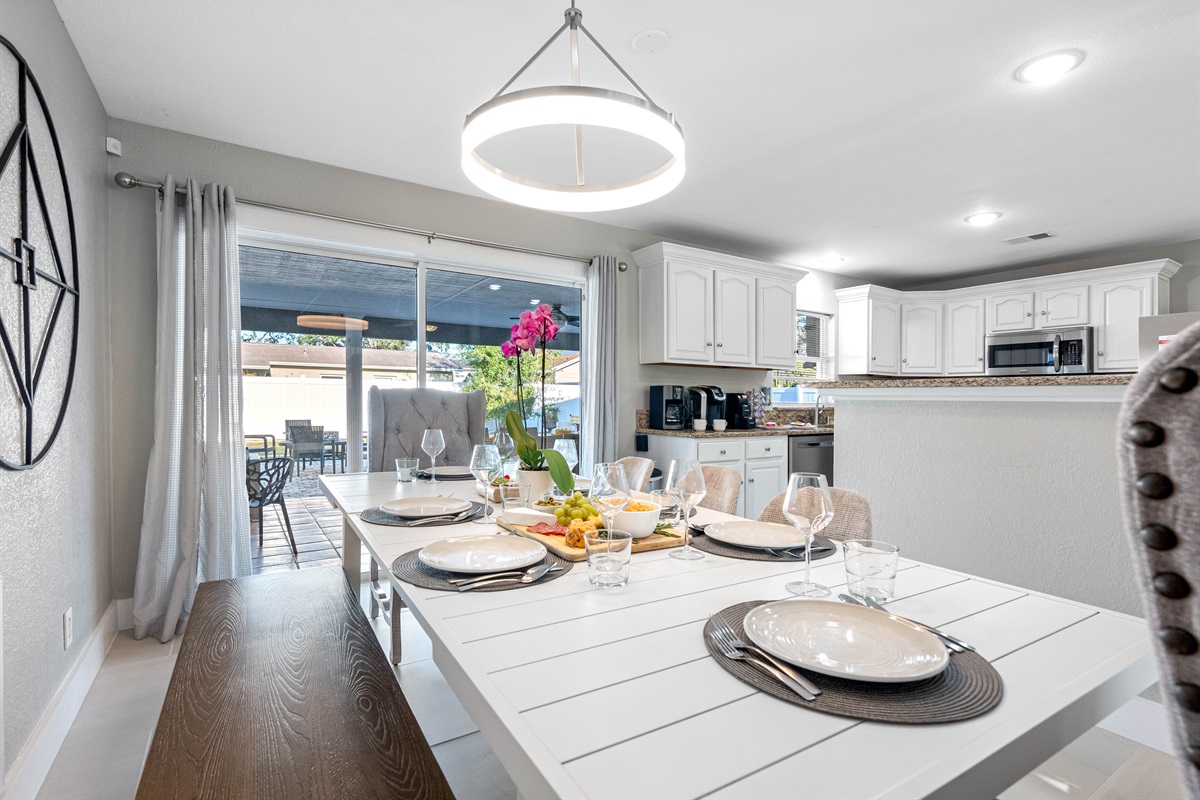A pristine dining area, comfortably accommodating eight guests, is conveniently located adjacent to our fully equipped kitchen, allowing you to prepare and enjoy your favorite homemade meals with ease.
