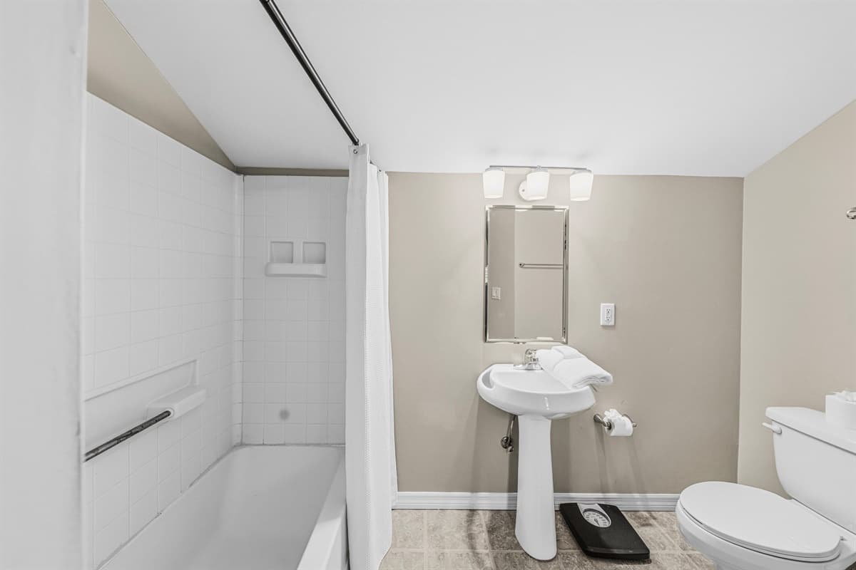 Additional full bathroom with simple, clean design and essential amenities.
