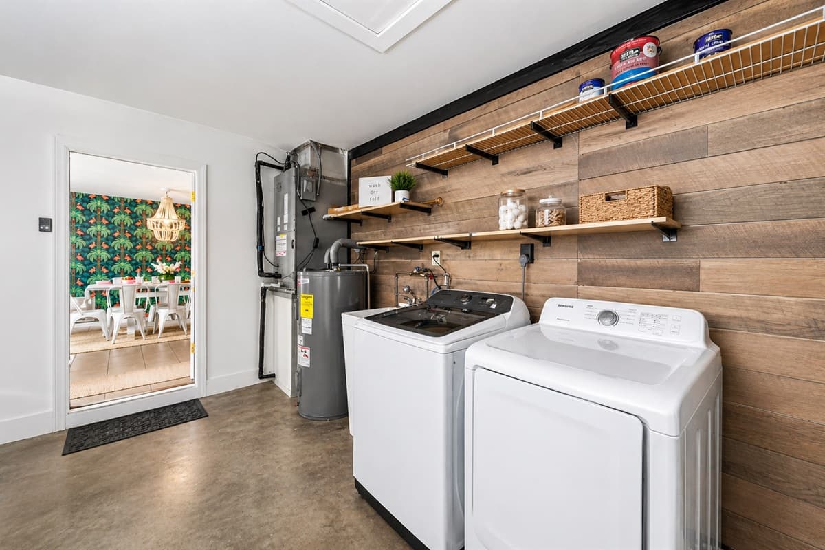 Convenient laundry area with washer, dryer, and shelving—perfect for longer stays.