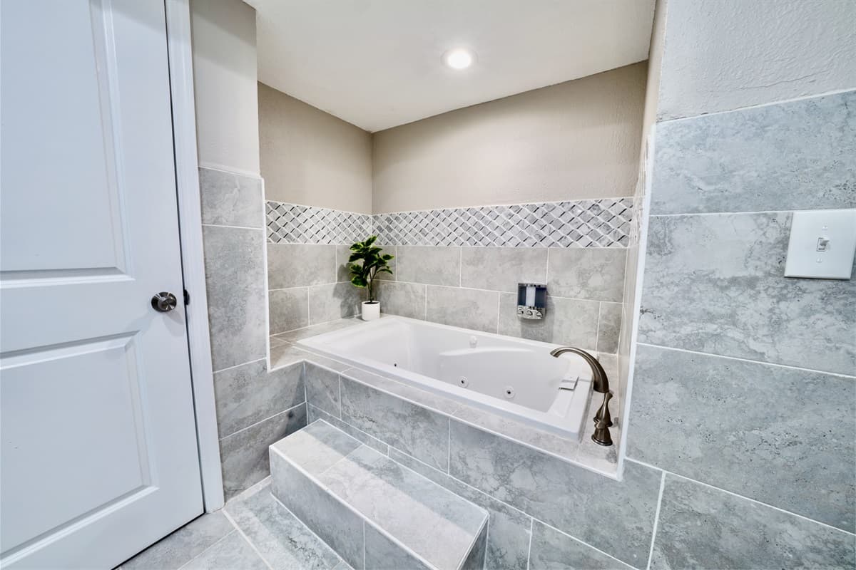 This well-appointed bathroom features both a separate walk-in shower and a deep soaking tub, offering you the choice of a quick invigorating rinse or a leisurely bath to unwind.