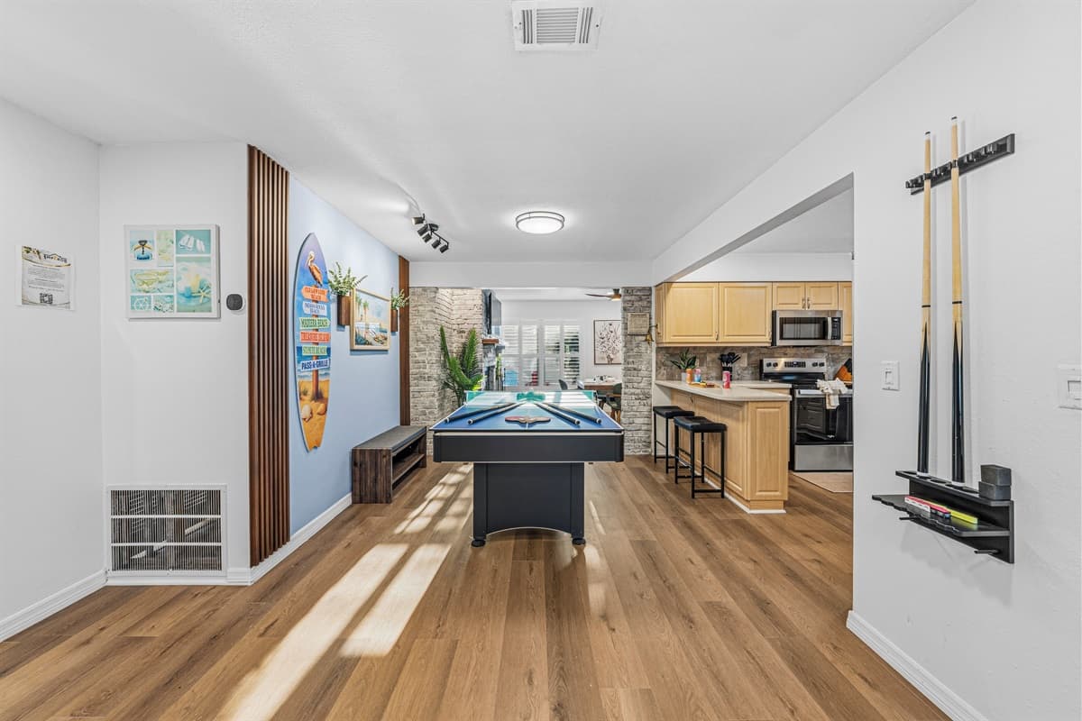 Spacious entertainment zone connecting the game area to the kitchen—great for social gatherings 