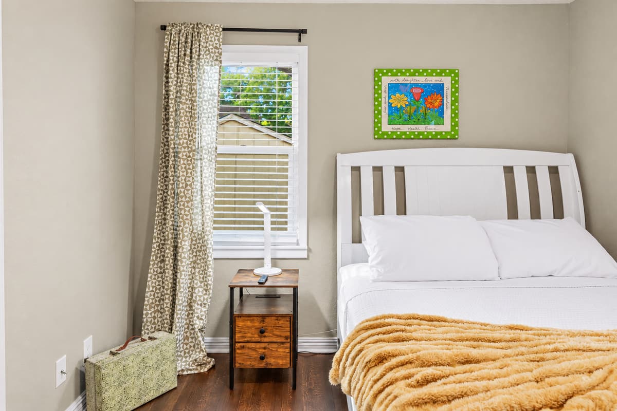 Cozy bedroom with comfortable bed, soft linens, and natural light—perfect for a restful stay.