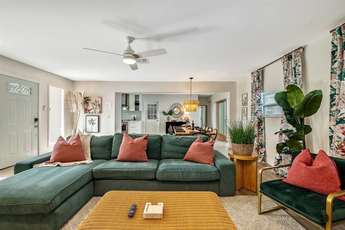 A plush sofa upholstered in soothing shades of sand and coral beckons you to sink into its embrace, offering a perfect spot to unwind after a long day.