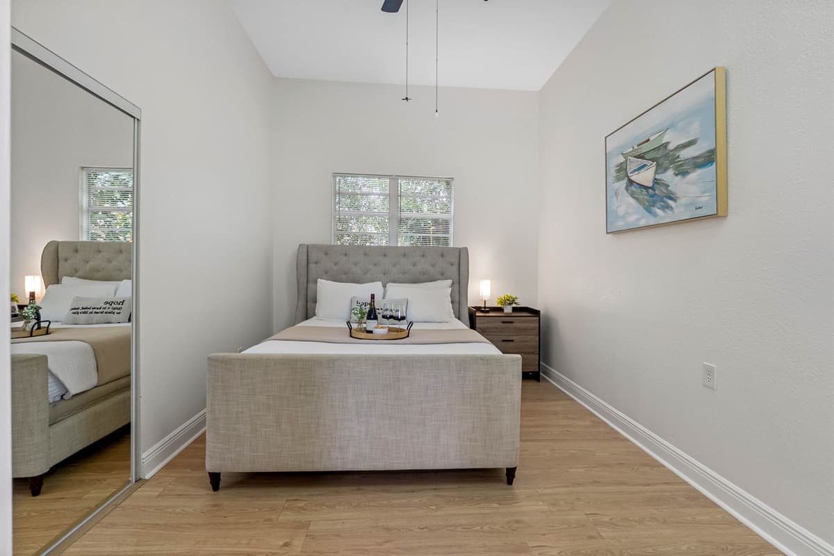Thoughtfully styled with warm wood accents and cozy textures, this bedroom blends modern comfort with a relaxed coastal vibe.