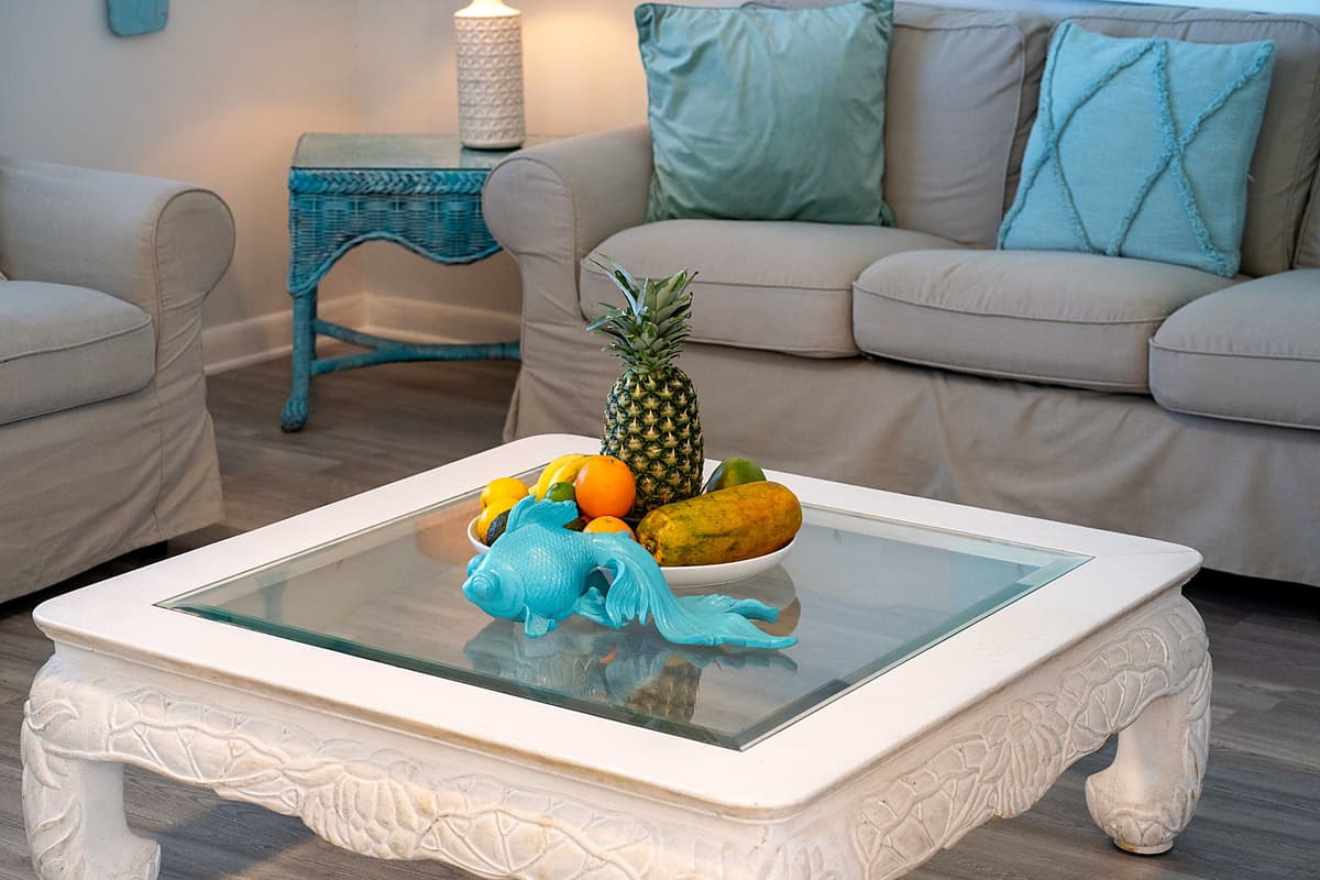 Natural light floods in through large windows, enhancing the room’s airy feel and adding to the tranquil coastal vibe.