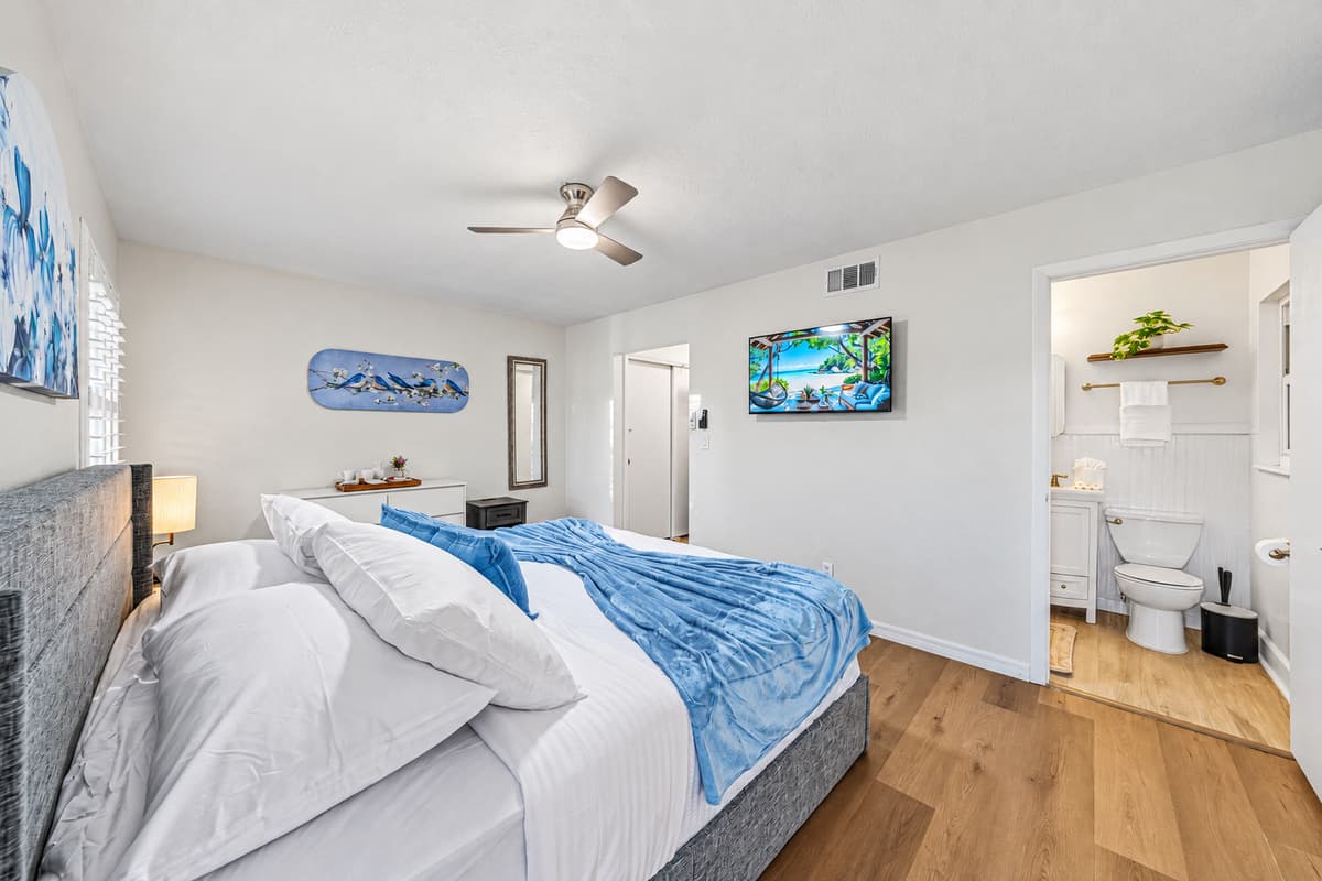 Spacious king bedroom with TV and direct access to an ensuite bathroom for added convenience 
