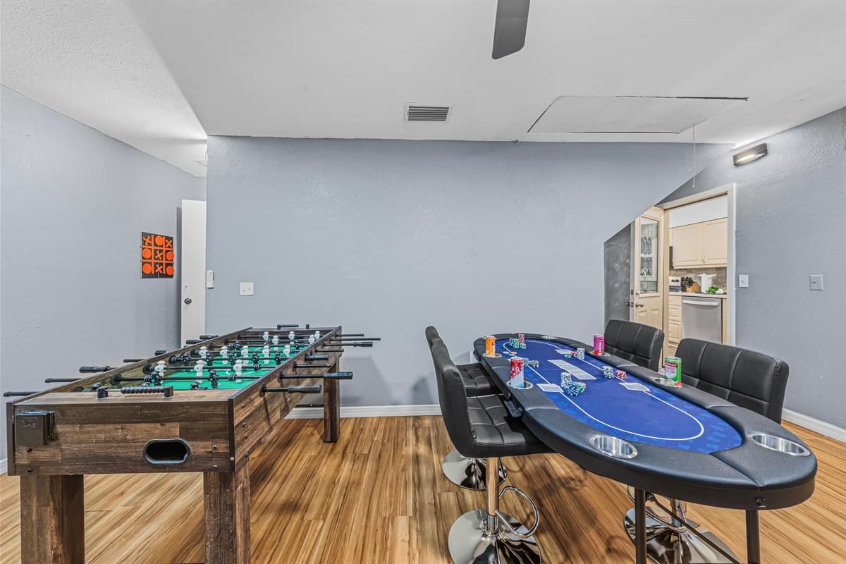 Large entertainment room featuring foosball and poker table—perfect for game nights with your group 