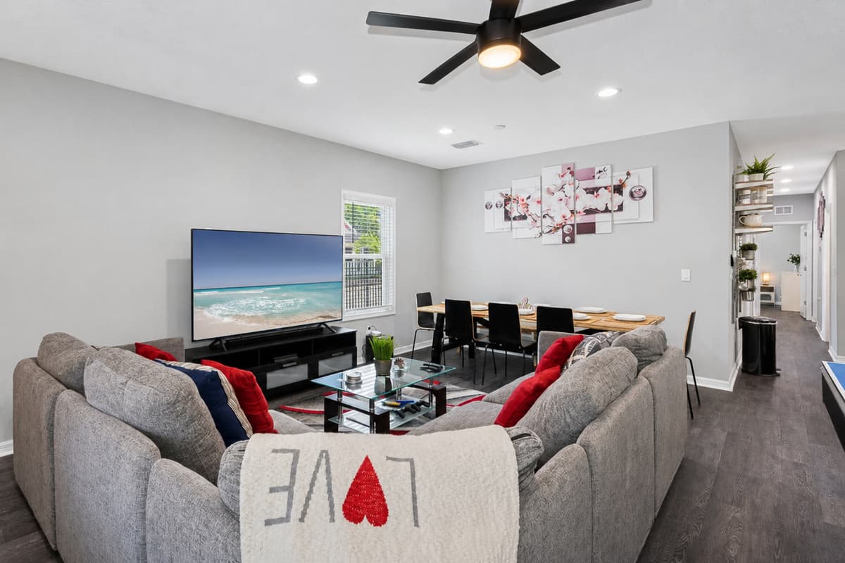 To complement the modern aesthetic, sleek and minimalist furniture pieces such as a contemporary coffee table and minimalist shelving units complete the living room ensemble.