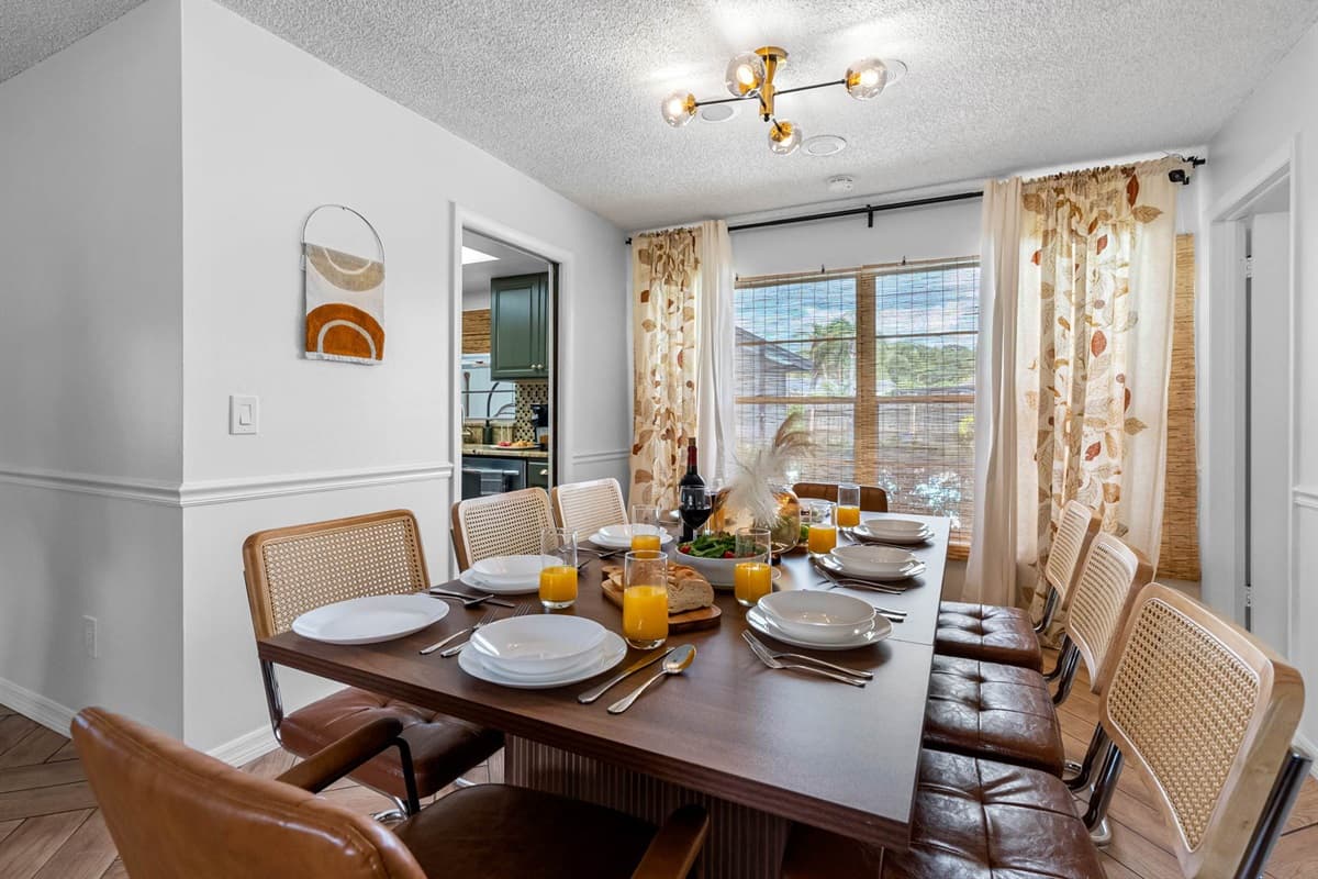 Enjoy sunlit meals in this inviting dining space, where earthy tones and natural textures create a warm, welcoming atmosphere.