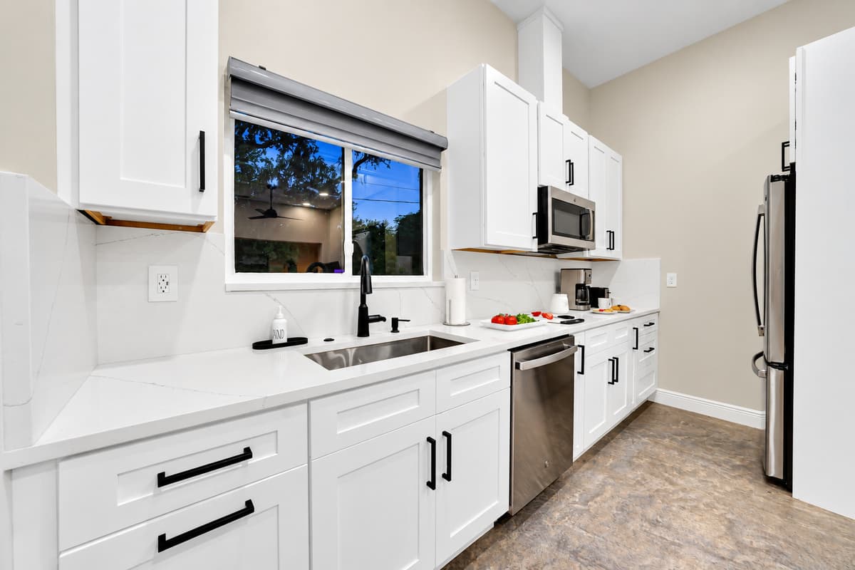 Two kitchens means two breakfasts at the same time. Full-size fridge, dishwasher, range and counter space of its own, so the early group eats at seven and the late group never hears about it.