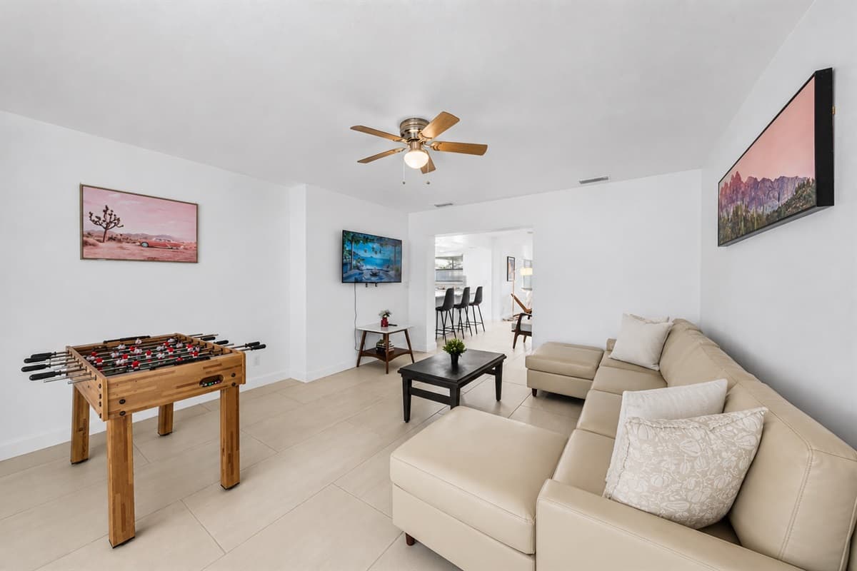 Fun-filled entertainment area featuring foosball table, spacious seating, and modern décor.