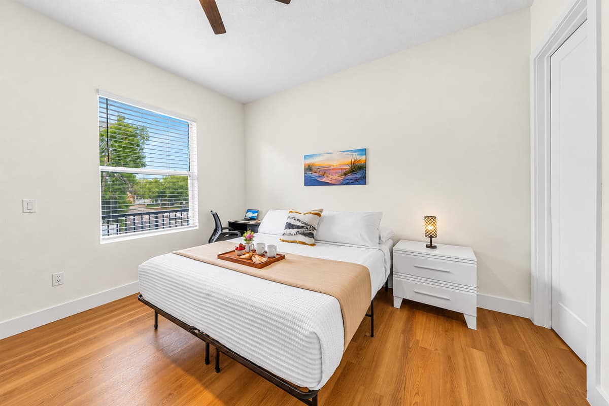 Cozy bedroom with comfortable bed, natural light, and clean, modern design.
