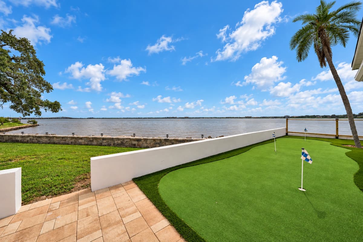 Paver patio meets putting green. Smooth pavers lead to the turf green and the seawall. Shoes off, coffee in hand and nowhere to be.