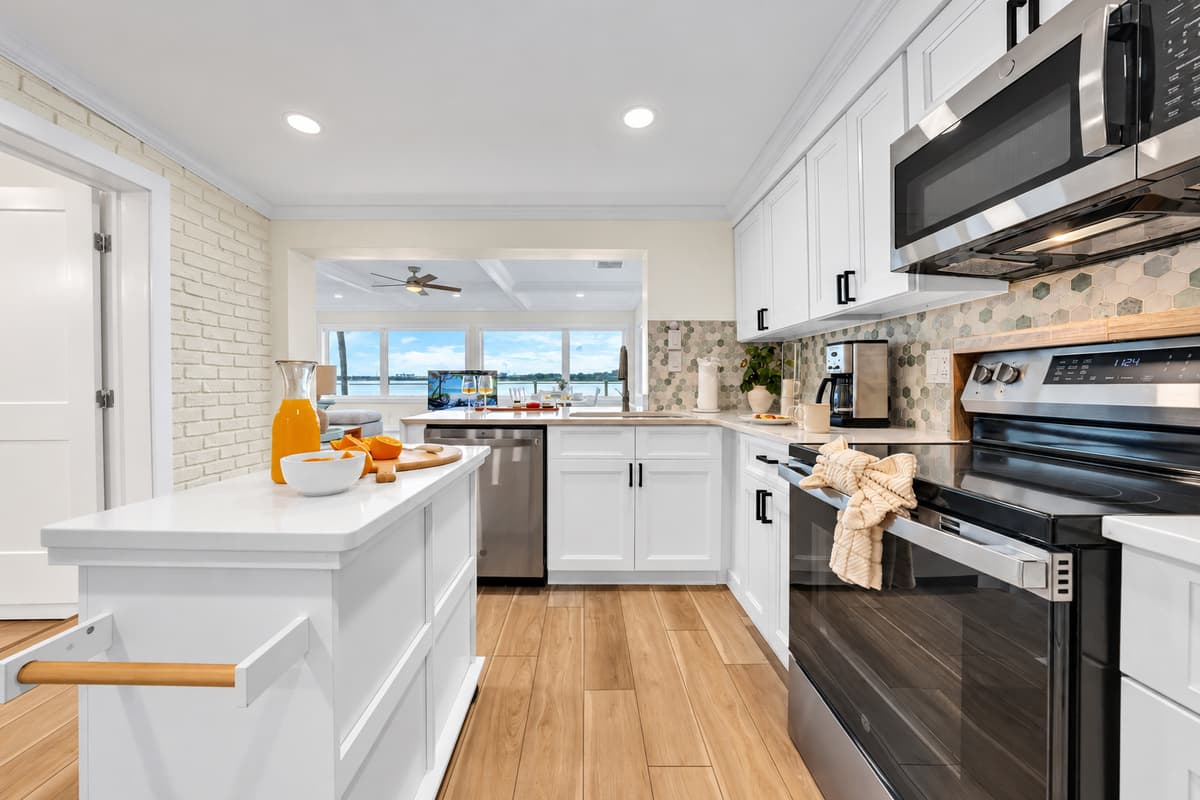 Cook with the water in the background. The galley-style kitchen leads straight to the waterfront room. Prep a meal while the bay sparkles through the windows.