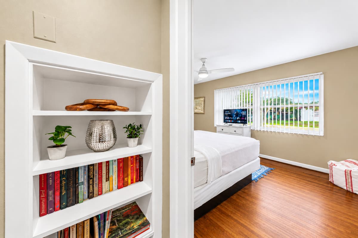 Charming bedroom entry view with decorative shelving and a welcoming, homey atmosphere.