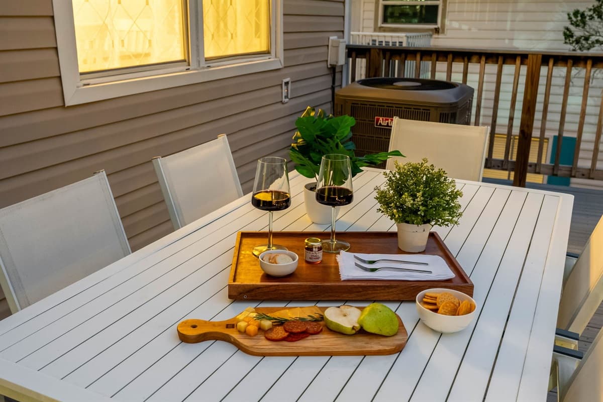 A stylish white dining table set for the perfect outdoor retreat.