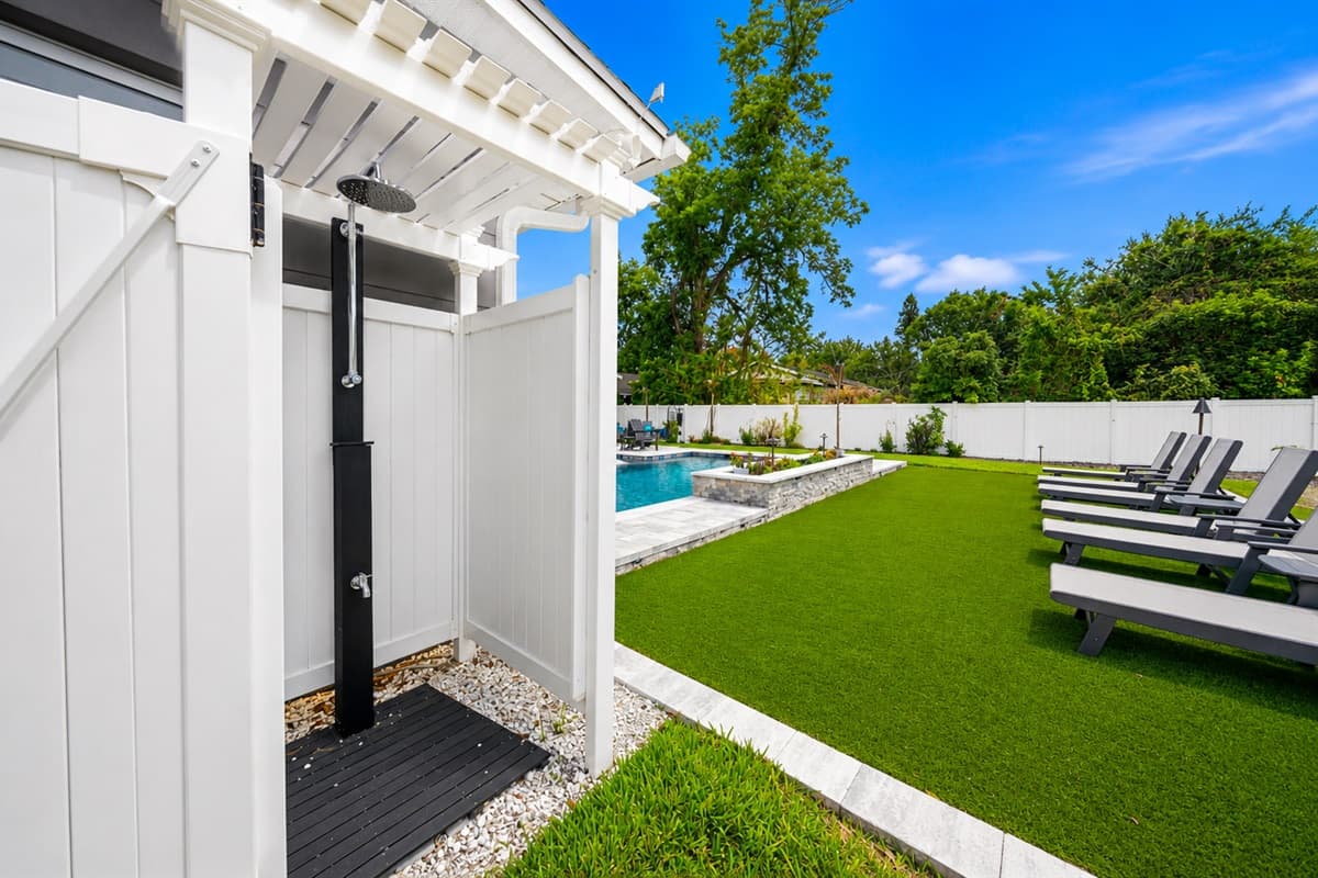 Convenient outdoor shower area perfect for rinsing off after enjoying the pool or outdoor activities.