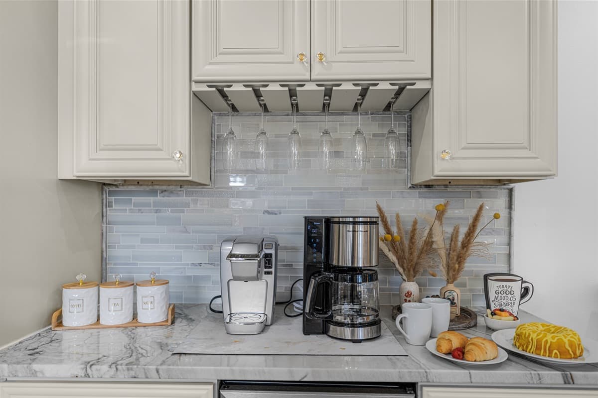 Enjoy a café-style experience right at home with this dedicated coffee station, complete with ample counter space and elegant finishes.