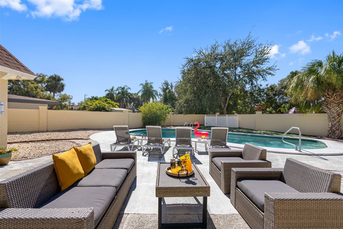 Enjoy long, lazy afternoons in this stunning pool area surrounded by palms and vibrant greenery — ideal for a relaxing getaway.