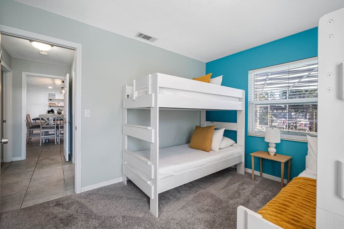 Perfect for kids or groups, this cheerful bunk room offers cozy twin-over-full beds and playful coastal colors.