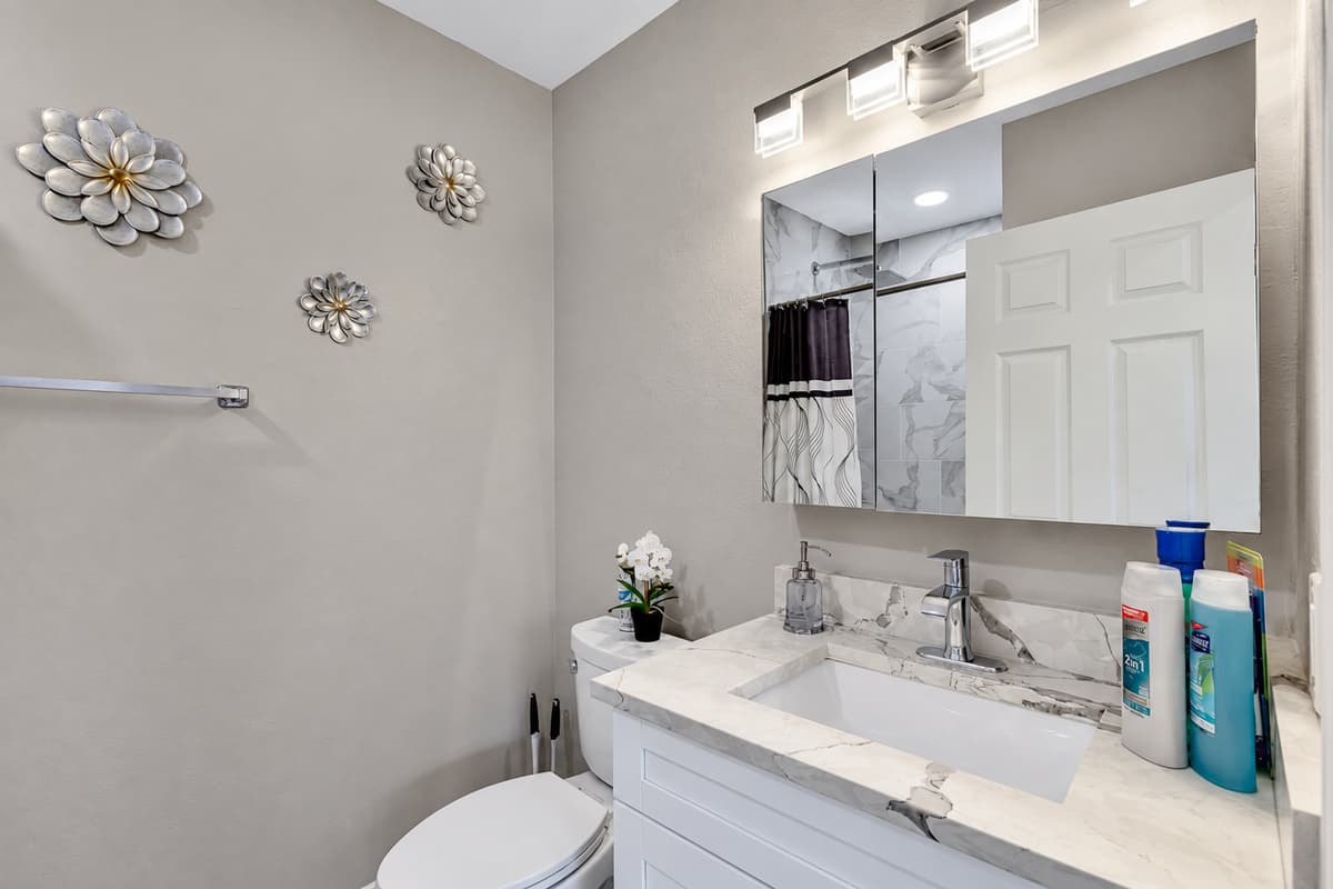 Beautiful bathroom with sink, toilet, and walk-in shower.  Enjoy a relaxing bath after a long day of travel from your home to your home away from home. If you like this property, send us a message now!