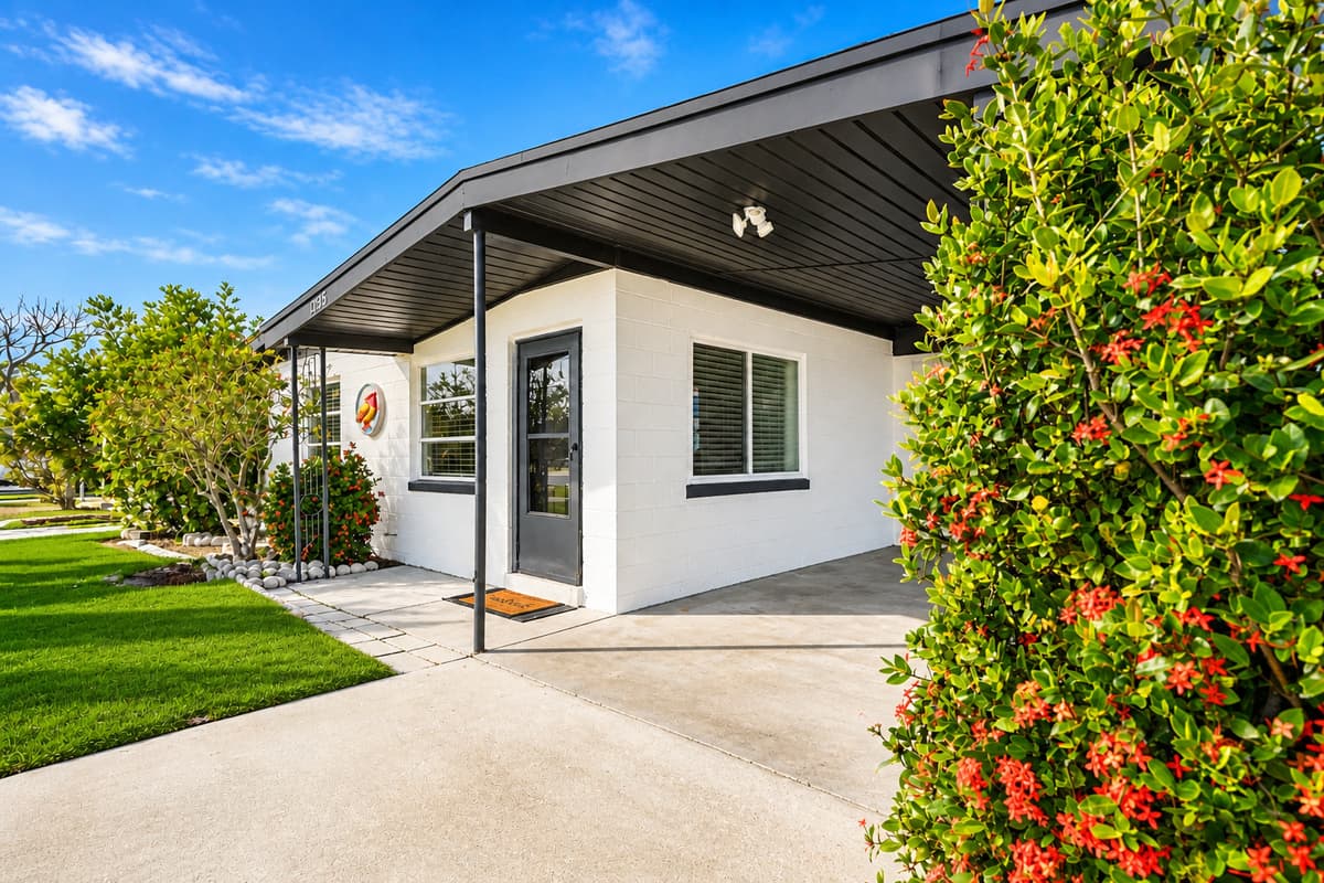 Exterior front corner view showcasing the home’s clean modern style and manicured landscaping.
