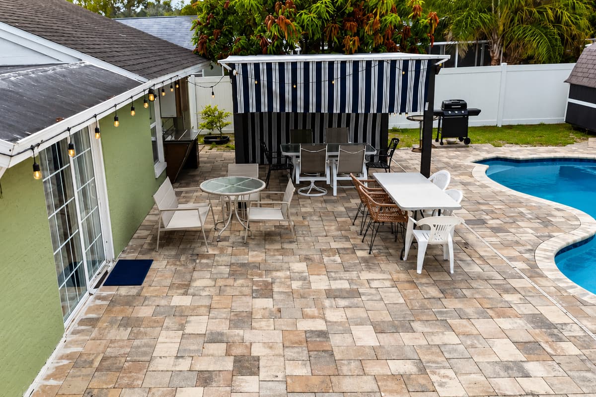 Expansive patio area with multiple seating options overlooking the private pool.